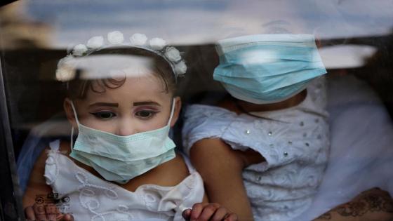 Una pareja de novios y sus invitados a la boda utilizan mascarillas médicas como medida de precaución contra el coronavirus (COVID-19), ocurrida durante la pandemia en Ciudad de Gaza.  Foto:  Ashraf Amra/ Anadolu